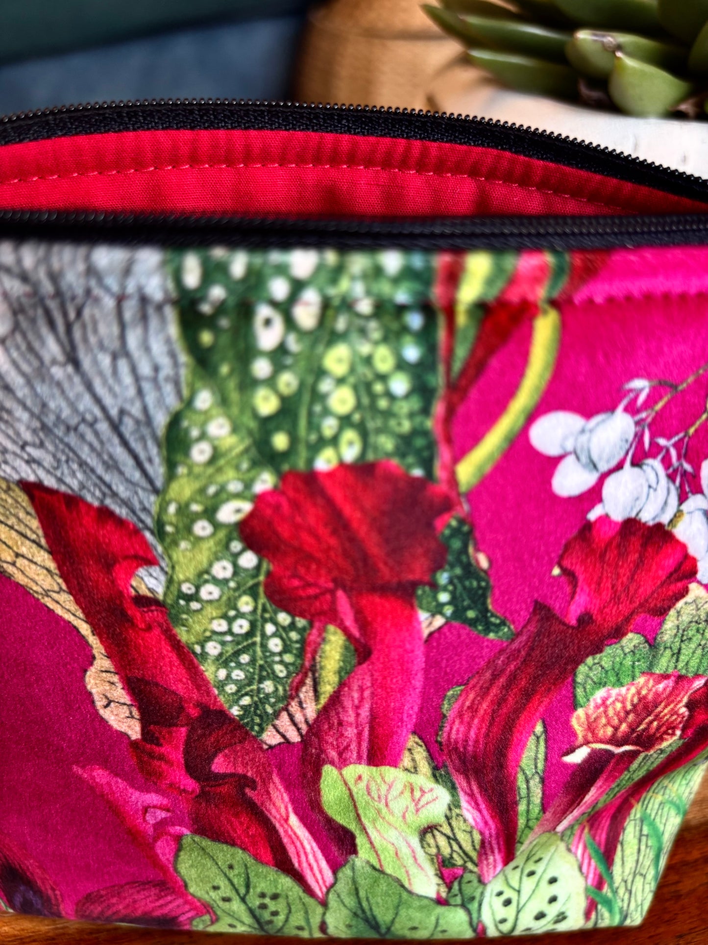 Cerise floral velvet small makeup bag with a black tassel. Handmade with red lining and diamanté pin button.
