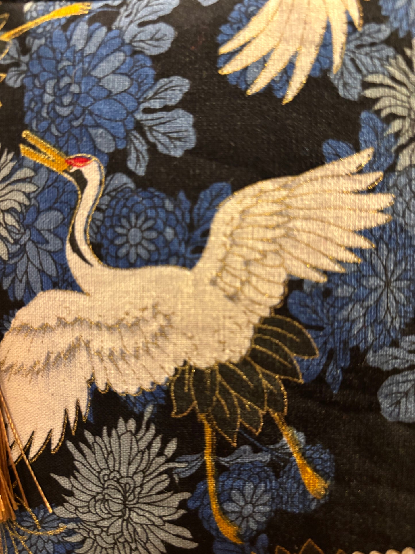 Crane print blue small makeup storage bag with gold foil detail. Gold tassel and red cotton lining.