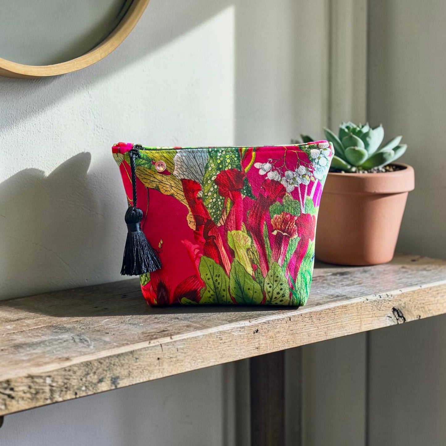 Cerise floral velvet small makeup bag with a black tassel. Handmade with red lining and diamanté pin button.