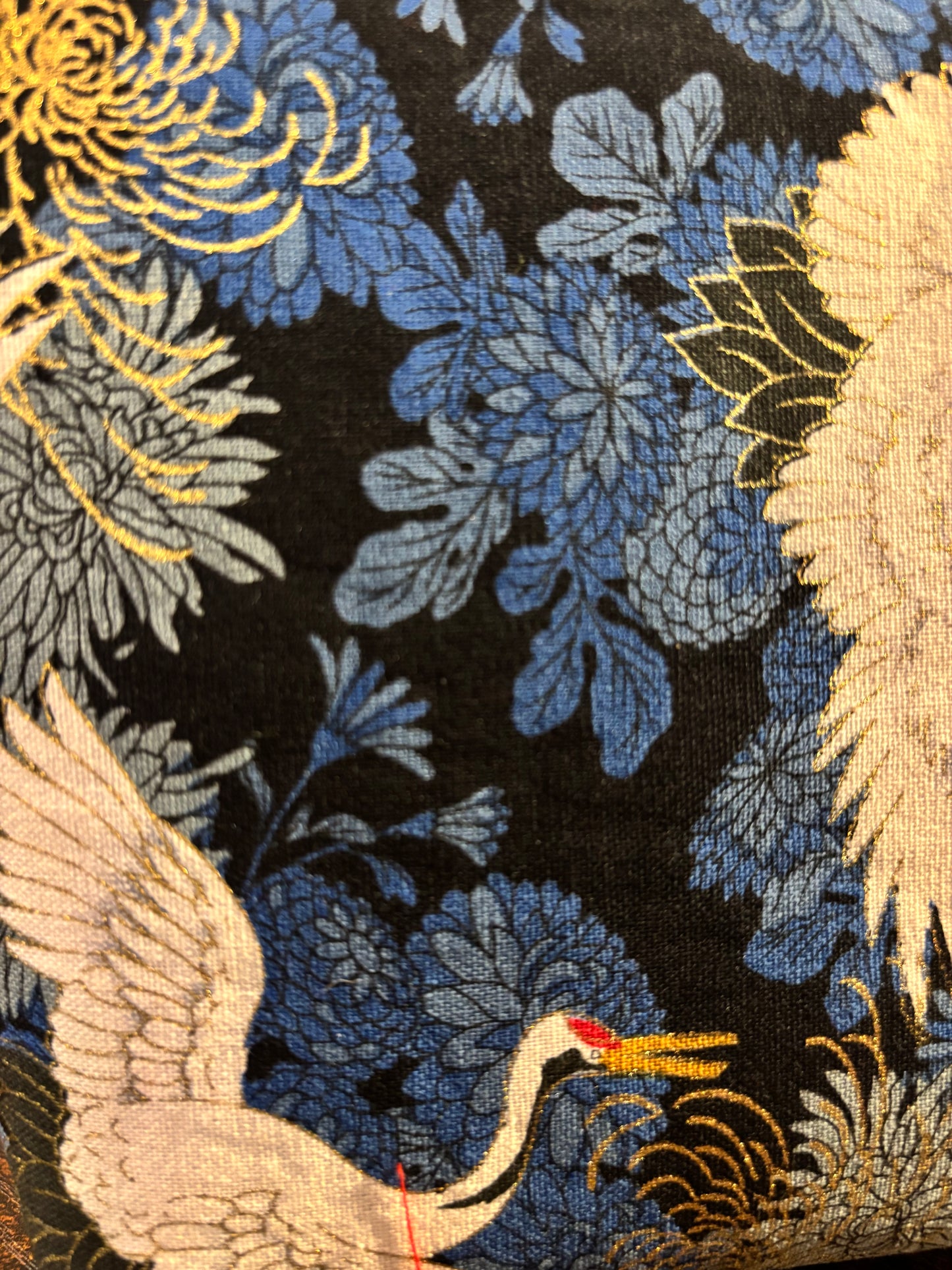 Crane print blue small makeup storage bag with gold foil detail. Gold tassel and red cotton lining.